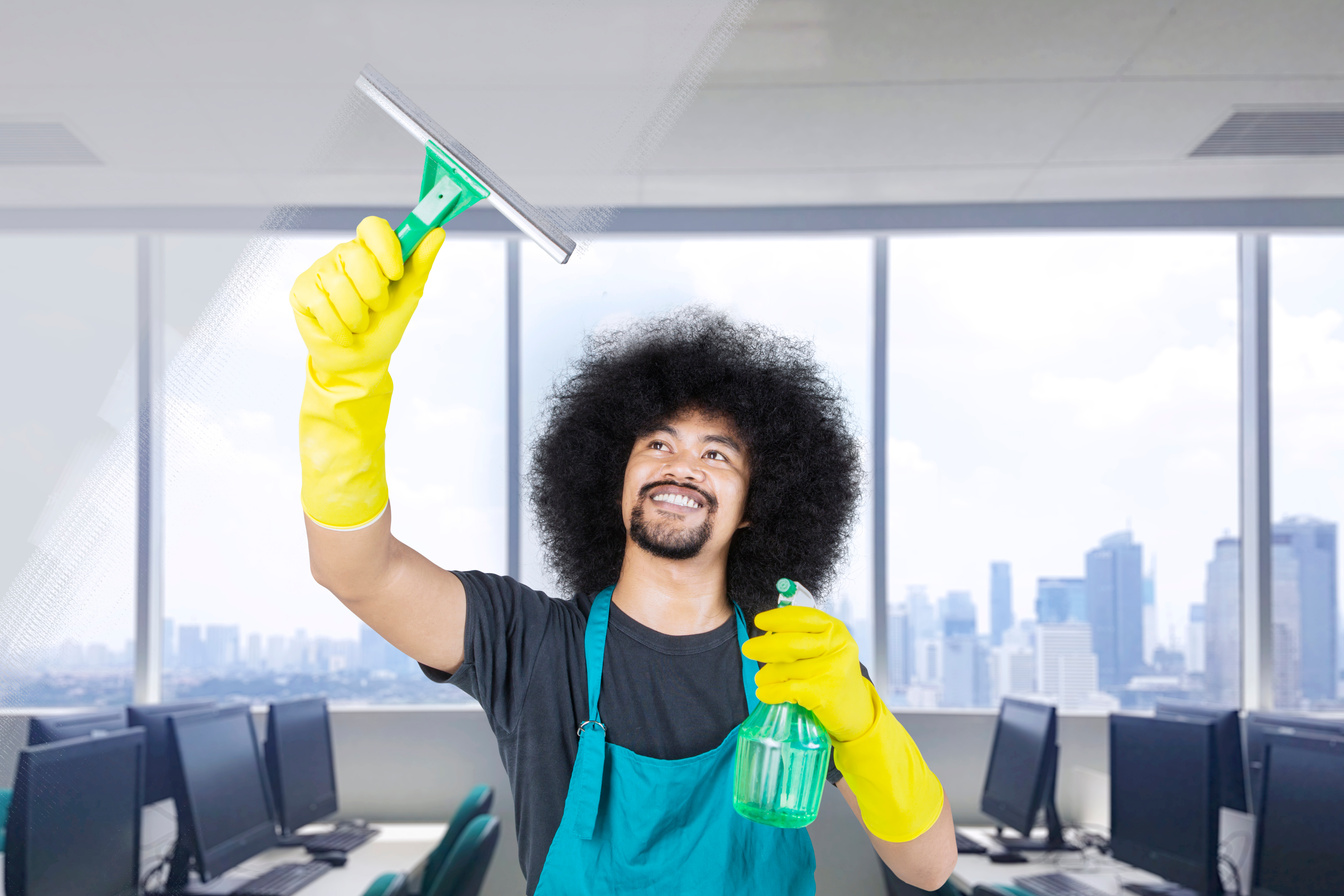 Cleaning Service Professional Cleaning the Office Window